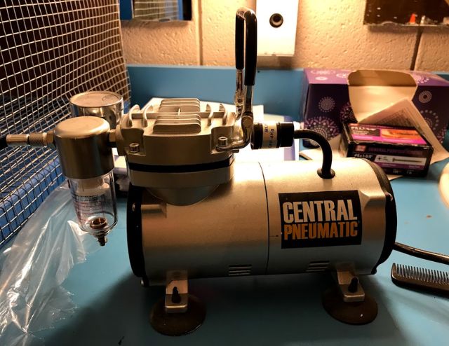 An airbrush air compressor.